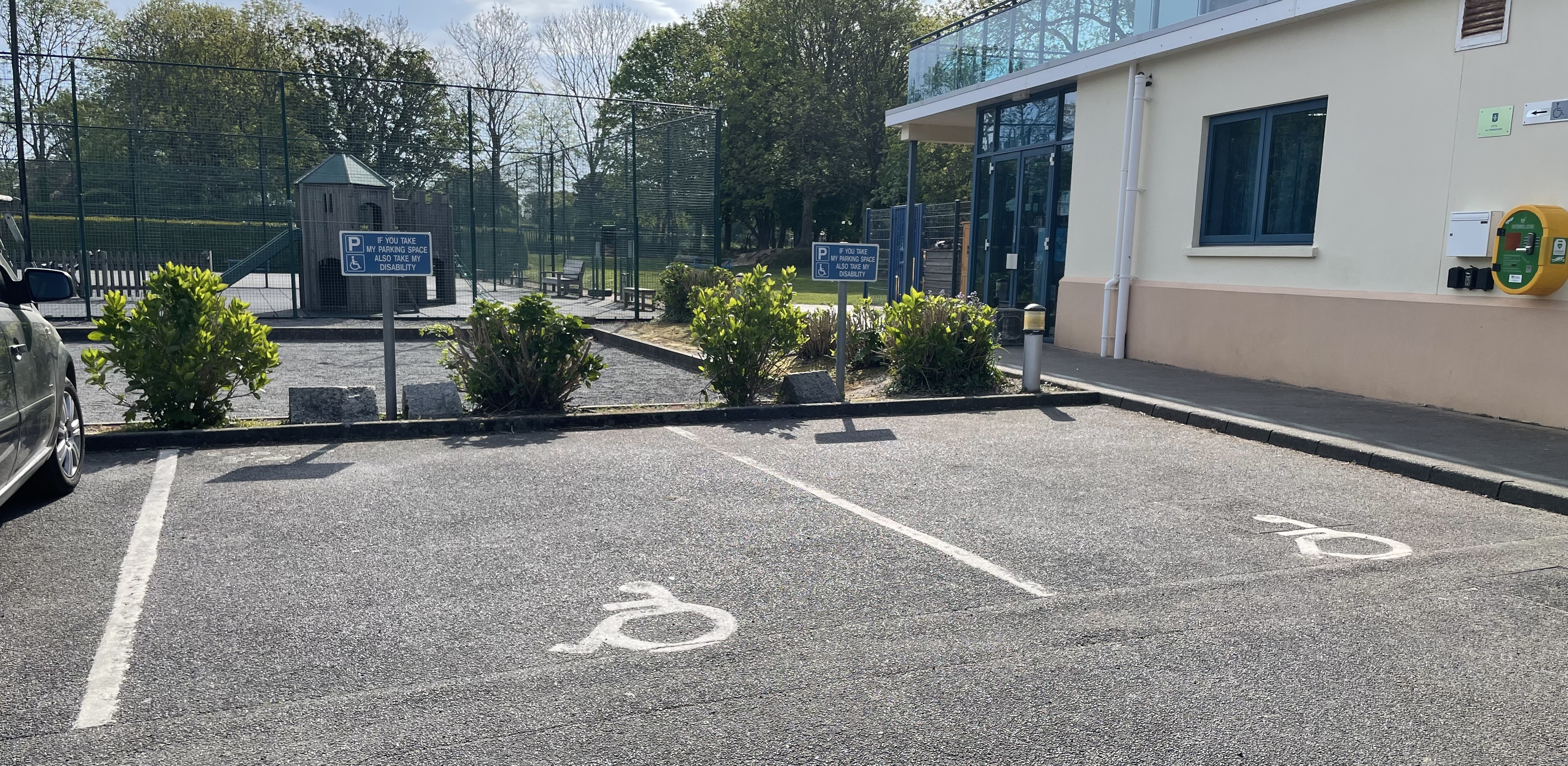 Accessible parking bays marked with wheelchair symbols outside St Mary Youth and Community Centre.