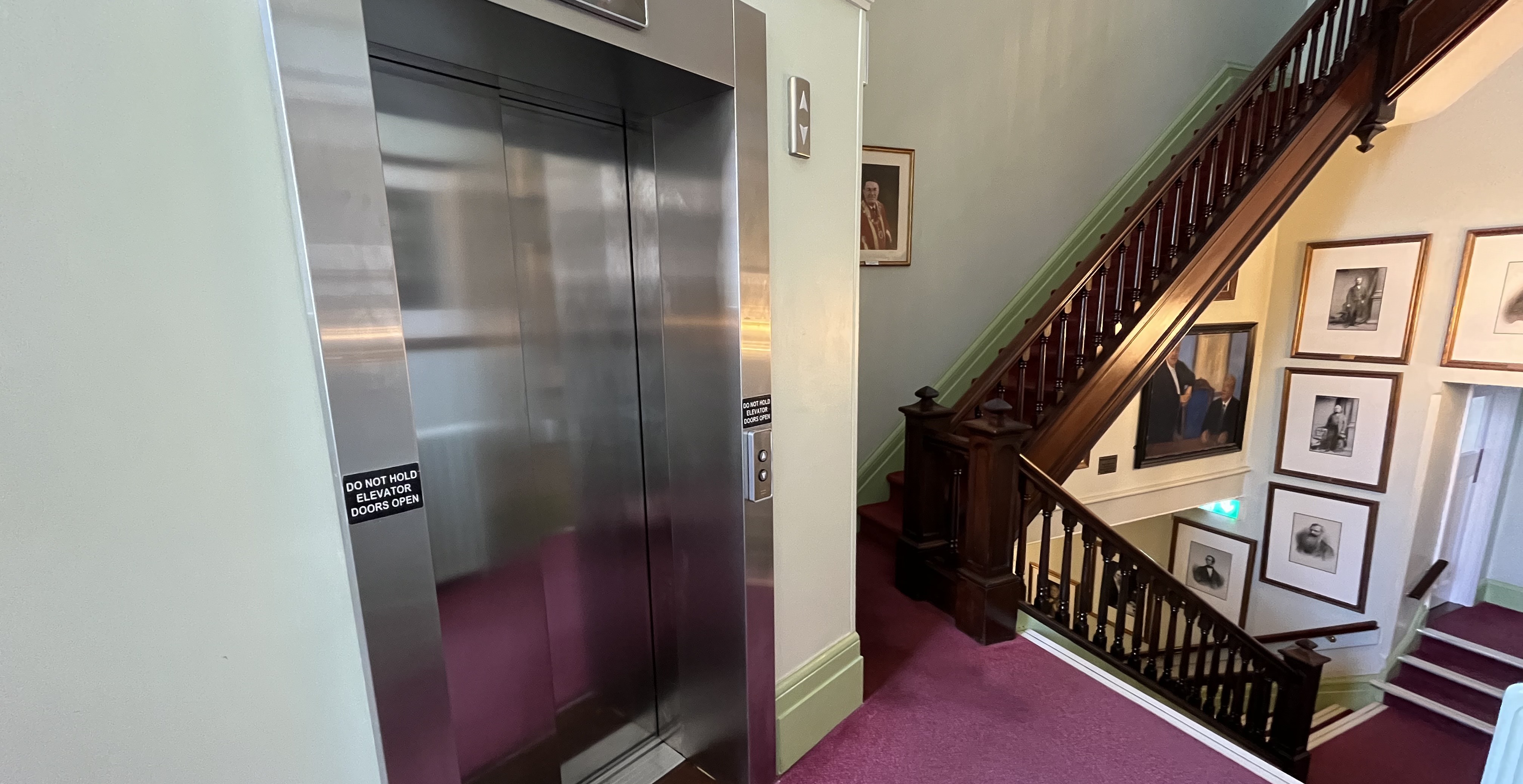The top of the stairs and lift next to polling room.