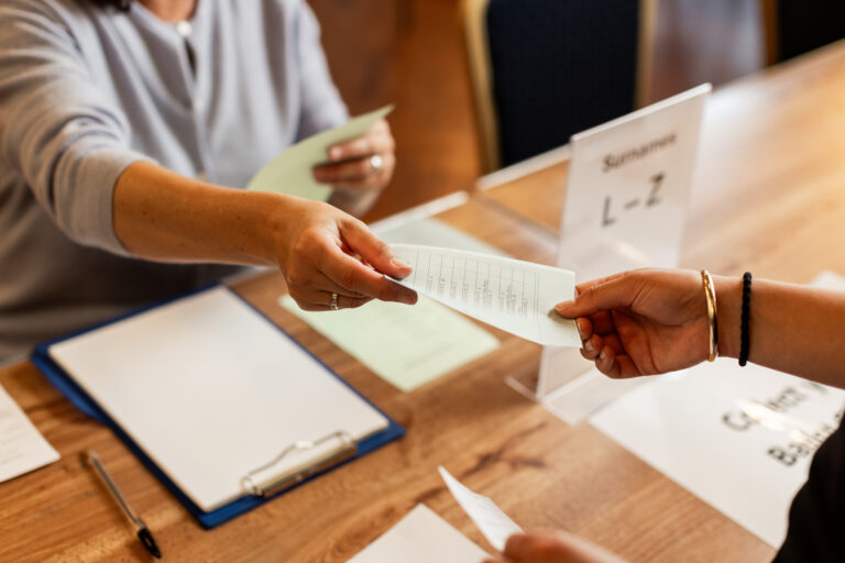 Voter being handed ballot