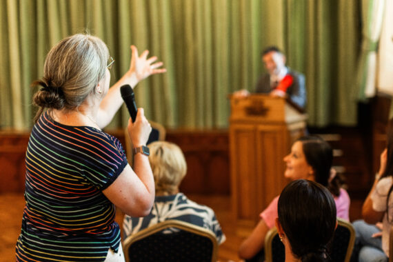 Member of the public speaking to a candidate during a hustings
