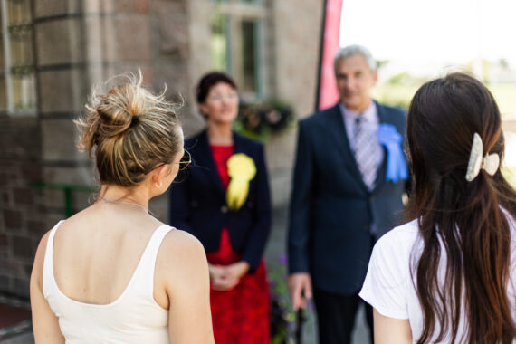 Two Candidates speaking to voters outside a polling station