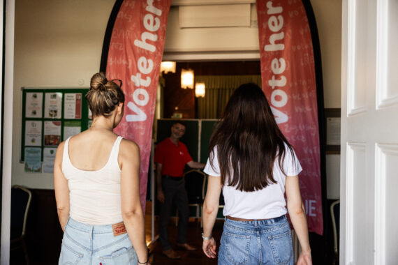 Members of the public being welcomed to polling station