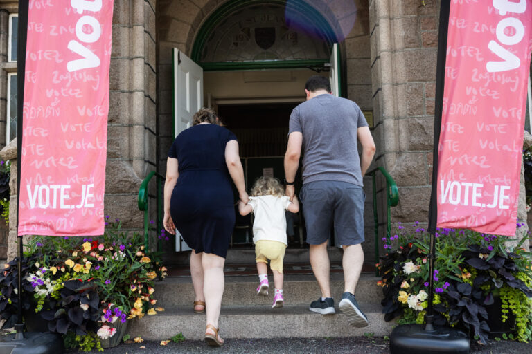 Parents and child entering polling station