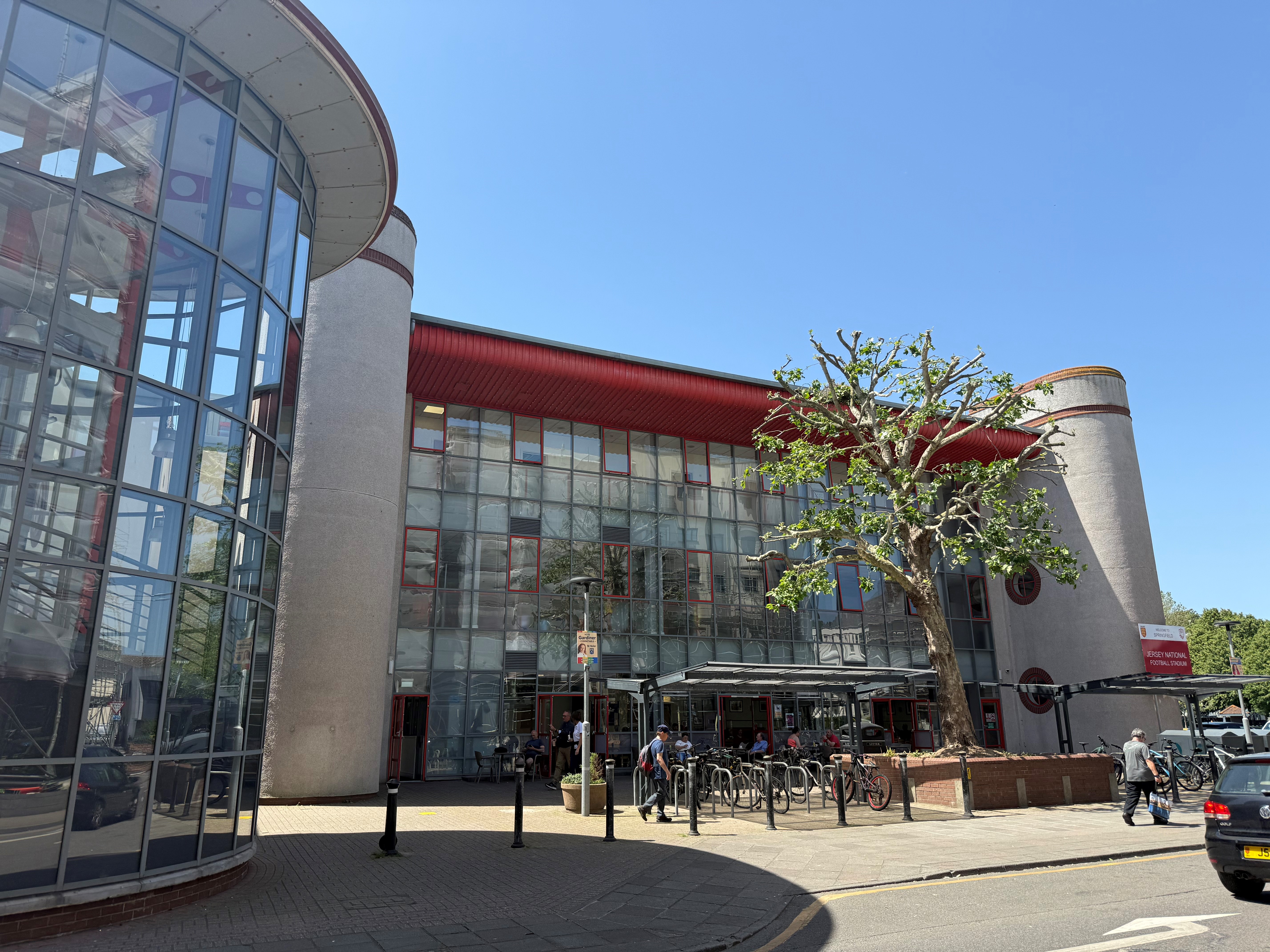 Exterior view of Springfield Stadium entrance with bicycle rack and tree in foreground