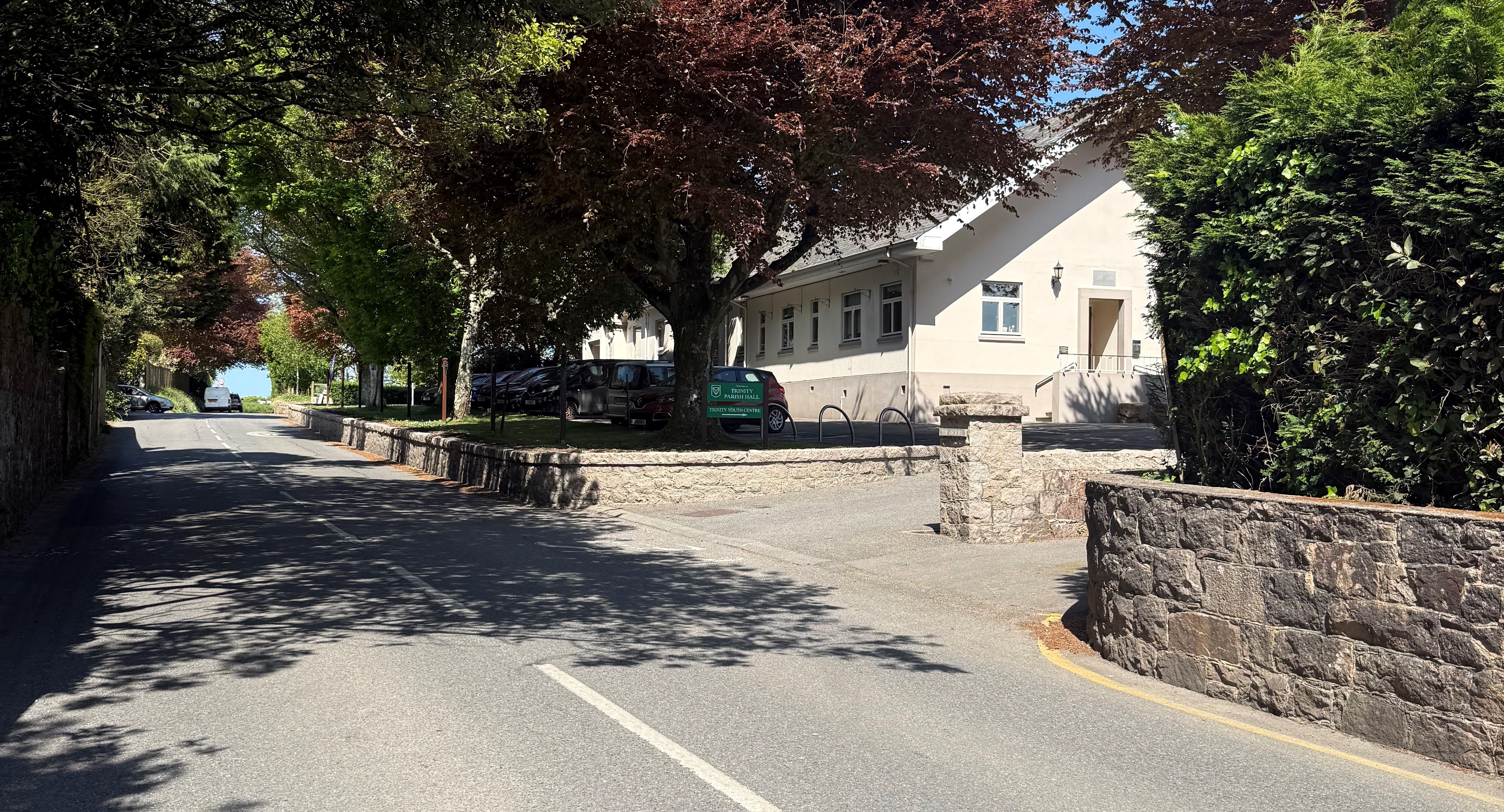 Approach to Parish Hall / Community Centre from main road (from South). Entrance on right hand side through a granite entranceway